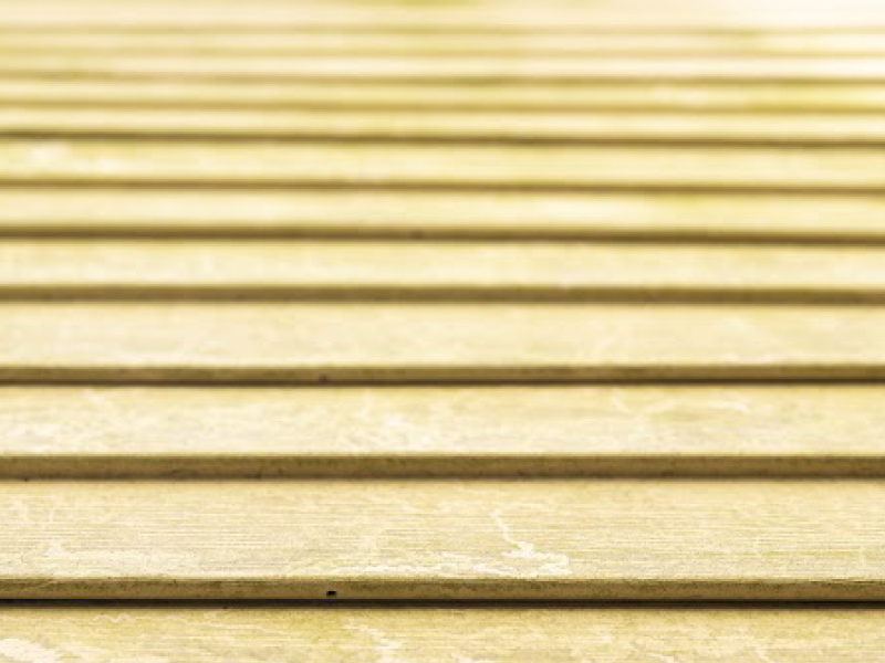 The image depicts a close-up view of a wooden floor, showcasing the texture and grain of a single wooden plank.